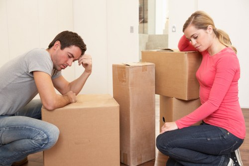 Mover carrying a sofa during a small removals service